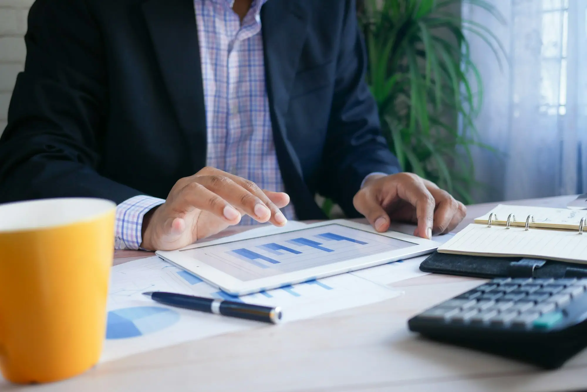 Accountant reviewing printed financial statements with a calculator