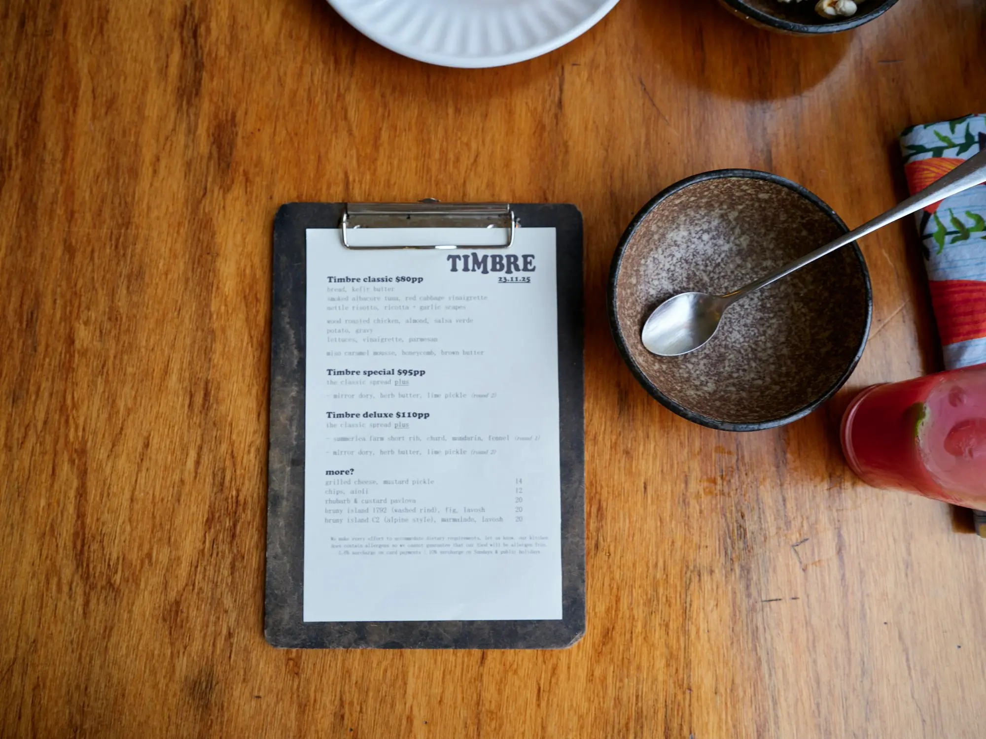 Cafe order clipboard and coffee on a timber table in Perth
