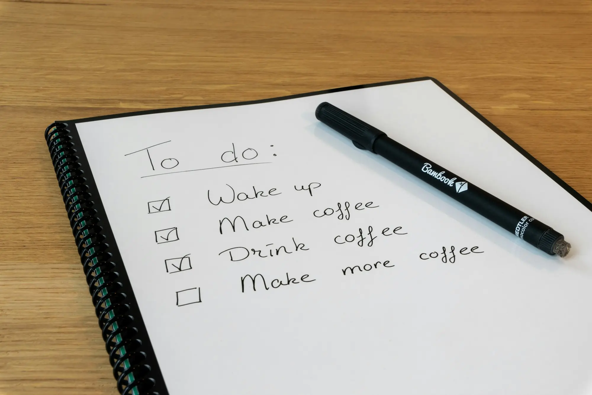 Handwritten to-do list in a notebook with a marker pen