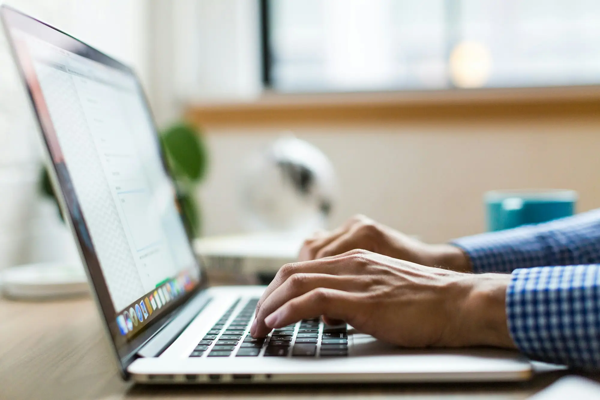 Business owner typing a question into a laptop